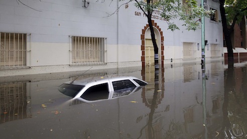 A submerged car is seen in a flooded street after a rainstorm in Buenos Aires