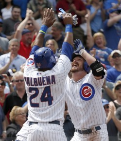 Chicago Cubs' Travis Wood, right, celebrates at home plate with Luis Valbuena::AP Photo:Charles Rex Arbogast