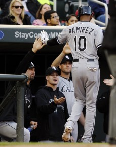 Chicago White Sox's Alexei Ramirez (10) is congratulated by teammates after scoring on Dayan Viciedo's::AP Photo:Genevieve Ross