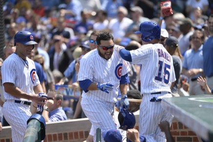 *Dioner Navarro #30 of the Chicago Cubs (C) is greeted at the dugout-- Brian Kersey-Getty Images-AFP