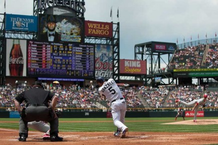 *Carlos Gonzalez #5 of the Colorado Rockies hits an RBI double off of--Dustin Bradford-Getty Images-AFP