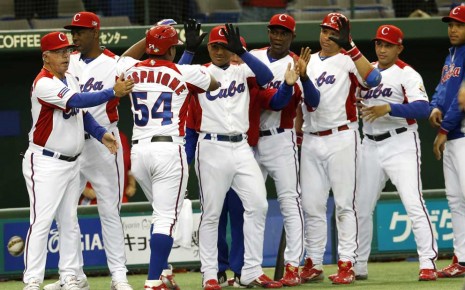 *Cuba's leftfielder Alfredo Despaigne (54) celebrates with teammates after hitting solo- homer--AP Photo-Koji Sasahara