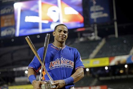 *American League's Yoenis Cespedes, of the Oakland Athletics, poses with the trophy--AP Photo-Kathy Willens