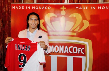 *Colombian forward Radamel Falcao poses while holding his new jersey--AFP PHOTO - VALERY HACHE