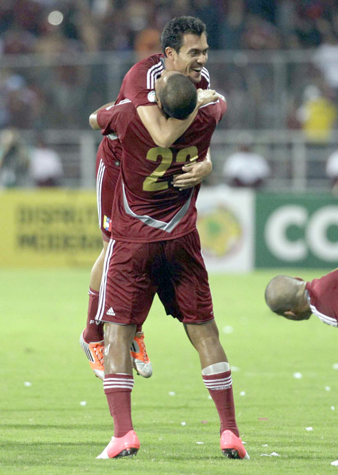 Venezuela's Juan Arango, top, celebrates with teammate Salomon Rondon after scoring-AP Photo-Ariana Cubillosweb