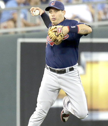 Cleveland Indians shortstop Asdrubal Cabrera tries to get control of the ball before aborting the throw--AP Photo-Charlie Riedelweb