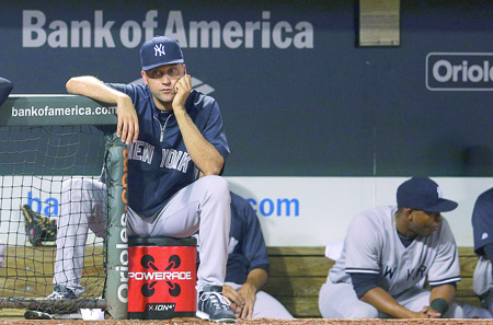 New York Yankees shortstop Derek Jeter looks on from the dugout during a baseball game against the Baltimore Orioles--AP Photo-Patrick Semanskyweb