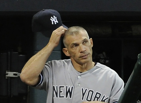 New York Yankees manager Joe Girardi scratches his head as he stands in the dugout in the 13th inningAP PhotoPat Sullivan