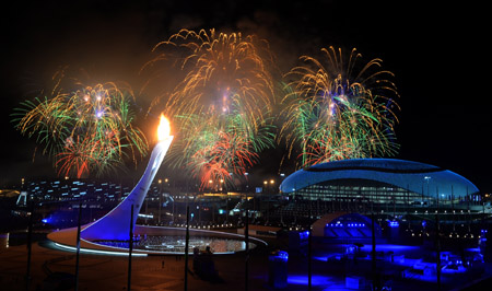 Fireworks light the sky over the Fisht Olympic Stadium as the Olympic flame::AFP PHOTO : PETER PARKS