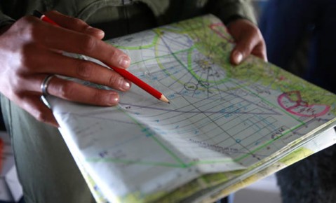 A military officer works on a map onboard a Royal Malaysian Air Force CN235 aircraft during a Search and Rescue (SAR) operation to find the missing Malaysia Airlines flight MH370, in the Straits of Malacca