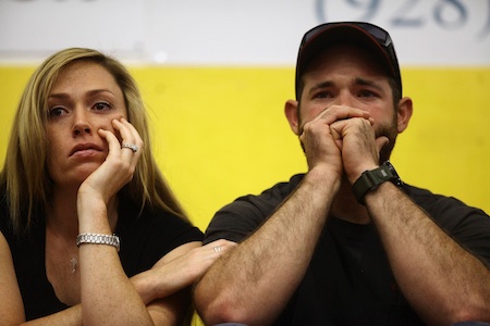 A couple cry as they listen to Arizona Governor Brewer speak during a news conference in Prescott
