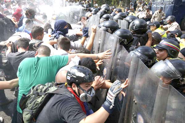 Anti-government protesters clash with the police during a protest in Caracas