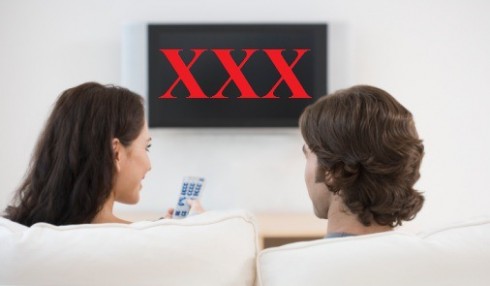 Rear view of couple watching television