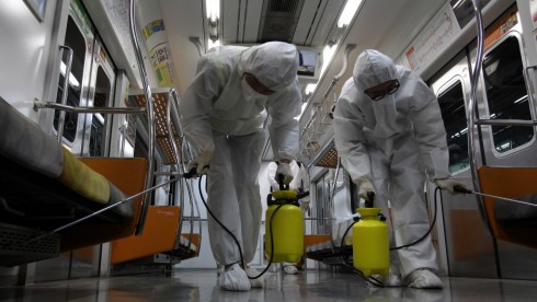 GOYANG, SOUTH KOREA - JUNE 09:  Disinfection workers wearing protective gears spray anti-septic solution in an subway amid rising public concerns over the spread of MERS virus at Seoul metro railway base on June 9, 2015 in Goyang, South Korea. South Korea has reported eighth death, 2,892 quarantined, and 1800 schools closed as of June 9, 2015.  (Photo by Chung Sung-Jun/Getty Images)