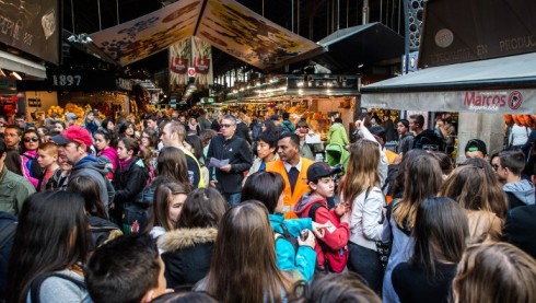 BARCELONA, SPAIN - APRIL 10:  A security staff member controls access to 'La Boqueria' green market on April 10, 2015 in Barcelona, Spain. Barcelona's city hall has put in place new regulations that ban large tourist groups visiting Barcelona's most popular market. Barcelona's authorities are debating how to control the number of tourist in the city as an estimated 10 million people are due to visit this year.  (Photo by David Ramos/Getty Images)