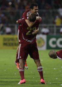 Venezuela's Juan Arango, top, celebrates with teammate Salomon Rondon after scoring:AP Photo:Ariana Cubillos