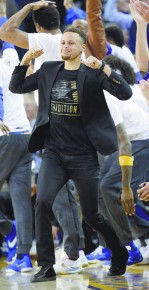 OAKLAND, CA - MARCH 01: Stephen Curry #30 of the Golden State Warriors celebrates on the bench after the Warriors scored a basket against the Atlanta Hawks at ORACLE Arena on March 1, 2016 in Oakland, California. NOTE TO USER: User expressly acknowledges and agrees that, by downloading and or using this photograph, User is consenting to the terms and conditions of the Getty Images License Agreement. Ezra Shaw/Getty Images/AFP