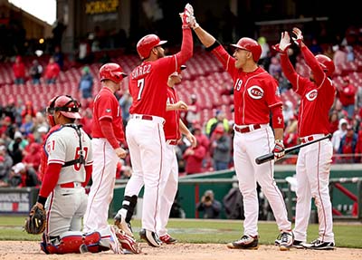 CINCINNATI, OH - APRIL 07: Eugenio Suarez #7 of the Cincinnati Reds is congratulated by Joey Votto #19 after hitting a grand slam home run in the 4th inning during the game against the Philadelphia Phillies at Great American Ball Park on April 7, 2016 in Cincinnati, Ohio.   Andy Lyons/Getty Images/AFP