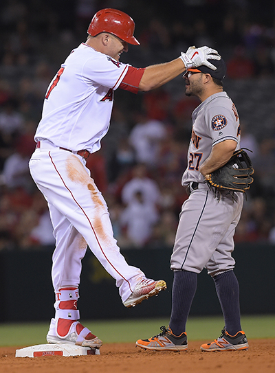 ANAHEIM, CA - JUNE 27: Mike Trout #27 of the Los Angeles Angels grabs Jose Altuve #27 of the Houston Astros on the head after he returned to second after sliding on the ground as he was heading for third base in the seventh inning of the game at Angel Stadium of Anaheim on June 27, 2016 in Anaheim, California.   Jayne Kamin-Oncea/Getty Images/AFP