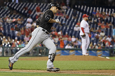 Miami Marlins' Martin Prado, left, rounds the bases after hitting the go-ahead home run off Philadelphia Phillies relief pitcher Brett Oberholtzer, right, during the 11th inning of a baseball game, Monday, July 18, 2016, in Philadelphia. Miami won 3-2 in 11 innings. (AP Photo/Matt Slocum)