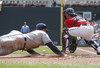 Houston Astros' George Springer, left, beats the throw to Minnesota Twins catcher Juan Centeno to score on a Jose Altuve double in the first inning of a baseball game Thursday, Aug. 11, 2016 in Minneapolis. (AP Photo/Jim Mone)