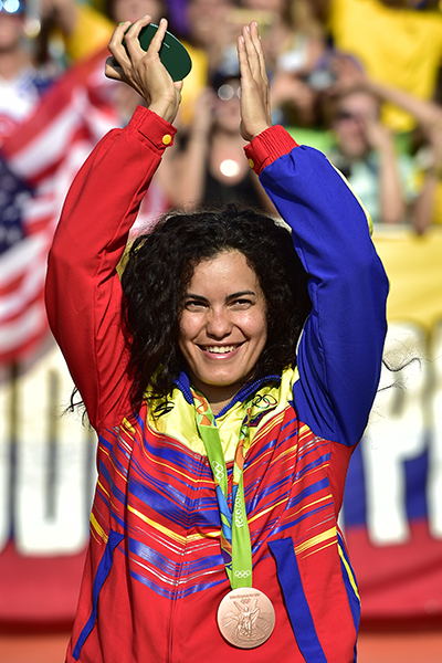 Bronze medallist Venezuela's Stefany Hernandez celebrates on the podium of the women's BMX cycling event of the Rio 2016 Olympic Games at the Olympic BMX Centre in Rio de Janeiro on August 19, 2016. / AFP PHOTO / CARL DE SOUZA