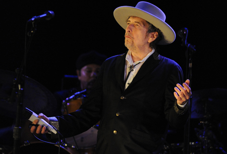 (FILES) This file photo taken on July 22, 2012 shows US poet and folk singer Bob Dylan performing during the 21st edition of the Vieilles Charrues music festivalin Carhaix-Plouguer, western France. US songwriter Bob Dylan won the Nobel Literature Prize on October 13, 2016, the first songwriter to win the prestigious award and an announcement that surprised prize watchers. / AFP PHOTO / FRED TANNEAU