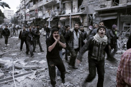 Opositores sirios lanzan consignas contra el régimen de Bashar al-Asad en una calle de la asediada Alepo, en el norte de Siria.
