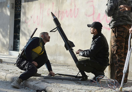 Los combatientes rebeldes se preparan para el lanzamiento de un cohete.