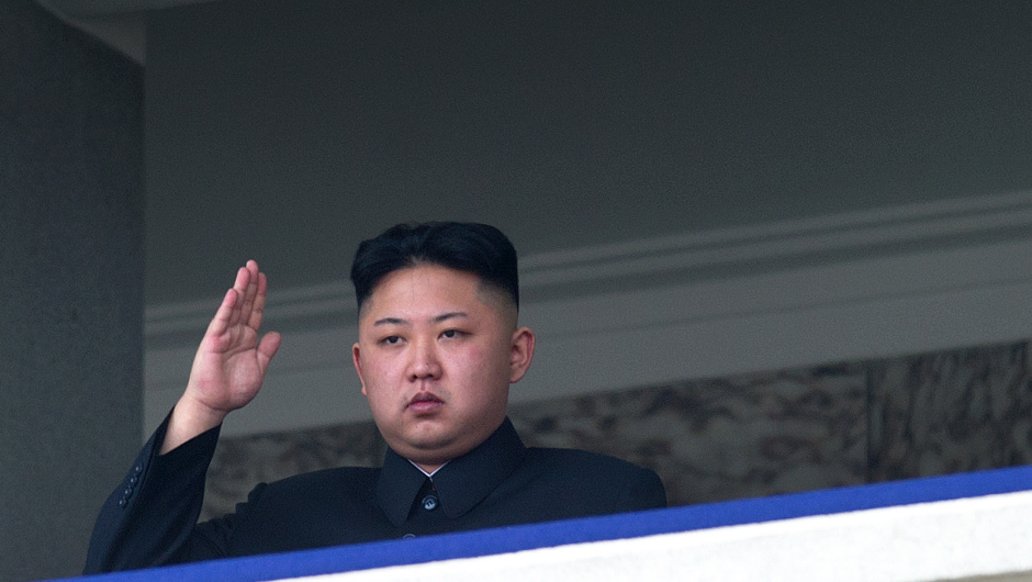 TO GO WITH Oly-2012-PRK,FEATURE(FILES) This file photo taken on April 15, 2012 shows North Korean leader Kim Jong-Un saluting as he watches a military parade to mark 100 years since the birth of the country's founder and his grandfather, Kim Il-Sung, in Pyongyang. He lacks the toned physique of an Olympian but "dear respected" leader Kim Jong-Un will be the inspiration when North Korea's athletes go for gold at the London Olympics.  North Korea are aiming for a record number of medals in London in what would be a timely boost for Kim, the new face of the country's ruling dynasty and its all-pervasive personality cult.      AFP PHOTO / FILES / Ed Jones        (Photo credit should read Ed Jones/AFP/GettyImages)