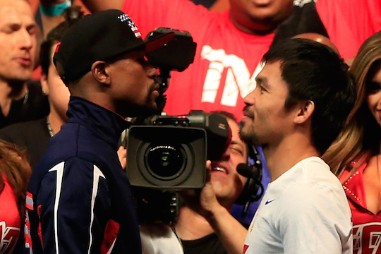 LAS VEGAS, NV - MAY 01: Floyd Mayweather Jr. (L) and Manny Pacquiao face off during their official weigh-in on May 1, 2015 at MGM Grand Garden Arena in Las Vegas, Nevada. The two will face each other in a welterweight unification bout on May 2, 2015 in Las Vegas.   Jamie Squire/Getty Images/AFP