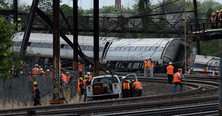 Rescuers work around derailed carriages of an Amtrak train in Philadelphia, Pennsylvania, on May 13, 2015. Rescuers on May 13 combed through the mangled wreckage of a derailed train in Philadelphia after an accident that left at least six dead, as the difficult search for possible survivors continued. AFP PHOTO/JEWEL SAMAD