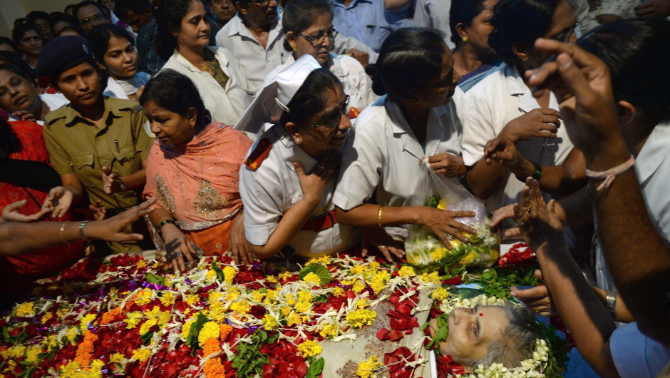 Indian nurses and hospital staff gather to pay their respect near the body of nurse Aruna Shanbaug at a hospital in Mumbai on May 18, 2015. Shanbaug died on May 18 after 42 years in a coma following a brutal rape, in a case that led India to ease some restrictions on euthanasia.  AFP PHOTO/ PUNIT PARANJPE        (Photo credit should read PUNIT PARANJPE/AFP/Getty Images)