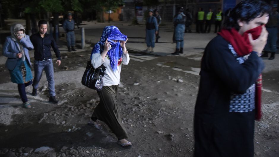 Afghan guests who were stuck inside a Kabul guesthouse walk after they were rescued by the security forces on May 13, 2015. Gunmen stormed a Kabul guesthouse popular with foreigners late on May 13 ahead of a planned concert, Afghan officials said, with people believed trapped inside and several casualties feared.No group immediately claimed responsibility for the attack on the Park Place guesthouse in downtown Kabul, but the assault comes as the Taliban -- who have attacked such guesthouses in the past -- press their annual spring offensive. AFP PHOTO / SHAH MARAI         (Photo credit should read SHAH MARAI/AFP/Getty Images)