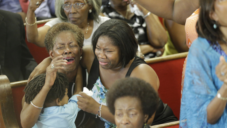 CHARLESTON, SC - JUNE 21:  Parishioners cry and embrace as they attend the first church service four days after a mass shooting that claimed the lives of nine people at the historic Emanuel African Methodist Church June 21, 2015 in Charleston, South Carolina. Chruch elders decided to hold the regularly scheduled Sunday school and worship service as they continue to grieve the shooting death of nine of its members including its pastor earlier this week.  (Photo by David Goldman-Pool/Getty Images)