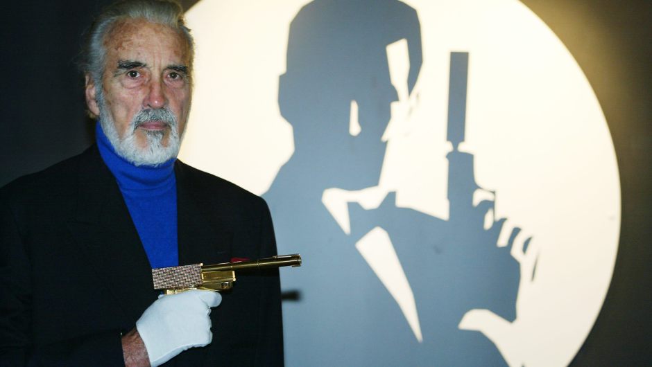 LONDON, UNITED KINGDOM:  Actor Christopher Lee holds the golden gun beside the Bond logo during the opening of the Bond, James Bond exhibit at The Science Museum in London 15 October 2002. Lee, appeared as Scaramanga in "The Man with the Golden Gun". The exhibit features memorabilia from 40 years of Bond movies. (Photo credit should read ADRIAN DENNIS/AFP/Getty Images)