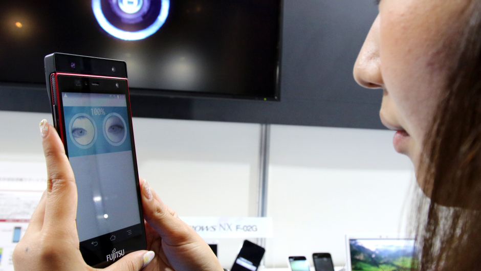 Japan's computer giant Fujitsu employee displays the prototype model of a smartphone with iris authentication system, which enables it to identify the user by iris-pattern instead of password or fingerprint at the preview of the company's high-tech exhibition in Tokyo on May 12, 2015.  Fujitsu is expecting to put in on the market this year.   AFP PHOTO / Yoshikazu TSUNO        (Photo credit should read YOSHIKAZU TSUNO/AFP/Getty Images)