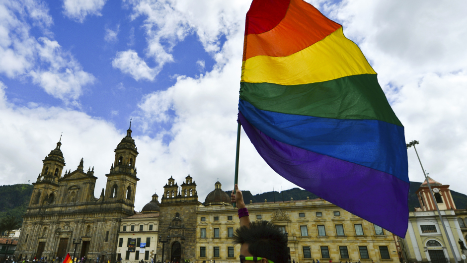 An activist holds a rainbow flag during a protest by the lesbian, gay, transgender and bisexual (LGTB) community demanding for their rigths --including gay marriage-- at the Bolivar Square in Bogota on November 27, 2012.    AFP PHOTO/Luis Acosta        (Photo credit should read LUIS ACOSTA/AFP/Getty Images)