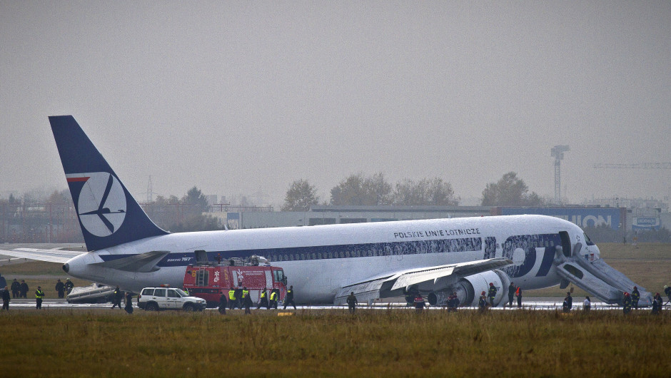 Fire engines and emergency vehicles surround a LOT Polish airlines Boeing 767 after it made an emergency landing at Warsaw's airport on November 1, 2011 after having problems lowering its landing gear. The plane had dropped fuel and circled above Warsaw for some time and a landing strip was especially prepared at the airport for the crash landing. No one was injured during the emergency landing according to a LOT spokesman.AFP PHOTO / WOJTEK RADWANSKI (Photo credit should read WOJTEK RADWANSKI/AFP/Getty Images)