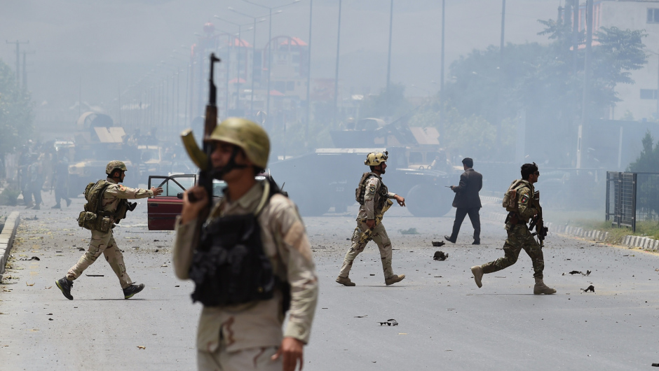 Afghan security personnel take position at the site of an attack in front of The Parliament Building in Kabul on June 22, 2015. Taliban militants attacked the Afghan parliament on June 22, with gunfire and explosions rocking the building, sending lawmakers running for cover in chaotic scenes relayed live on television.The insurgents tried to storm the complex after triggering a car bomb but were repelled and have taken position in a partially-constructed building nearby, officials said about the ongoing attack. All MPs were safely evacuated after the attack, which came as the Afghan president's nominee for the crucial post of defence minister was to be introduced in parliament. AFP PHOTO / SHAH Marai        (Photo credit should read SHAH MARAI/AFP/Getty Images)