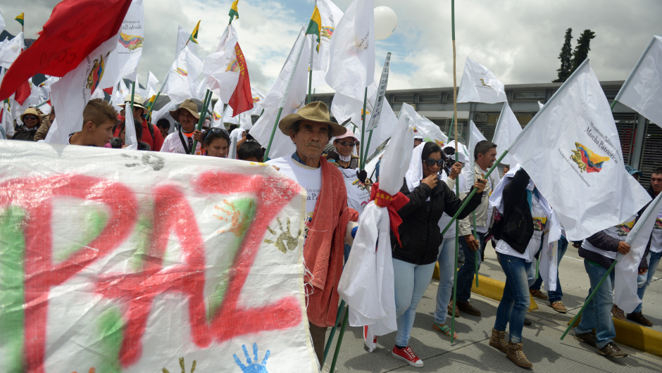 People march during a rally for peace in tribute to the victims of 50 years of conflict in Colombia, in Bogota, on April 9, 2015. The Colombian government is negotiating with the Marxist-inspired Revolutionary Armed Forces of Colombia (FARC) to end decades of bloody war which has killed around 220,000 people and uprooted more than five million since the FARC launched its rebellion in 1964.  AFP PHOTO / EITAN ABRAMOVICH        (Photo credit should read EITAN ABRAMOVICH/AFP/Getty Images)