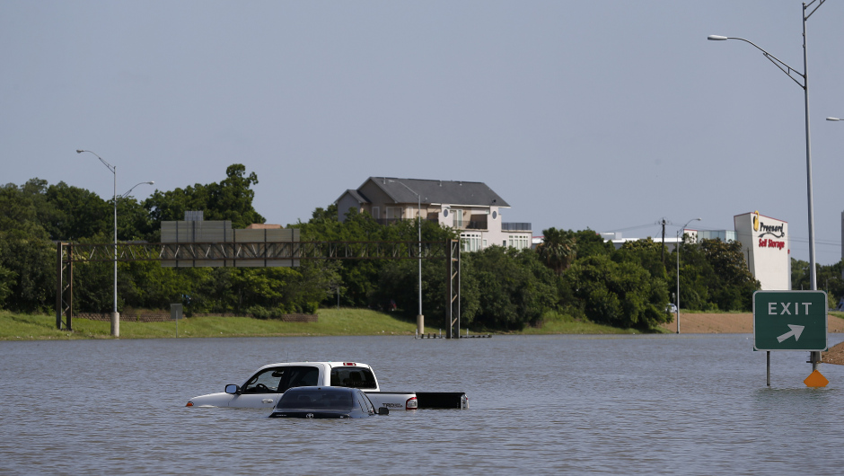 Vehicles are left stranded on Texas State Highway 288 in Houston, Texas on May 26, 2015.  Heavy rains throught Texas put the city of Houston under massive amounts of water, closing roadways and trapping residents in their cars and buildings, according to local reports. Rainfall reached up to 11 inches (27.9cm) in some parts of the state, according to national forecasters, and the heavy rains quickly pooled over the state's already saturated soil. AFP PHOTO/AARON M. SPRECHER        (Photo credit should read Aaron M. Sprecher/AFP/Getty Images)