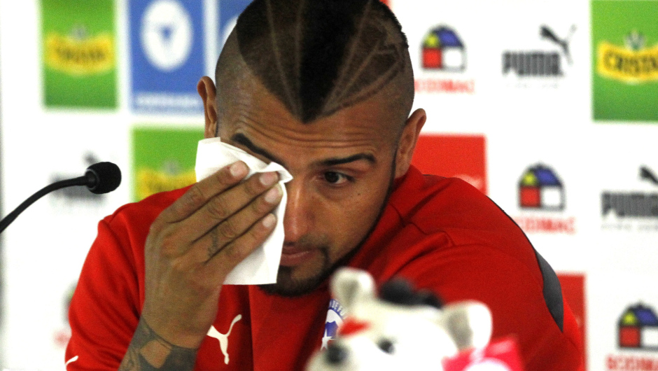 Chile's national football player Arturo Vidal sobs as he delivers a press conference in Santiago, on June 17, 2015. Vidal was stripped of his driver's license Wednesday after being arrested for crashing his Ferrari while driving drunk, but the national team decided not to suspend him from the Copa America. AFP PHOTO / CLAUDIO REYES        (Photo credit should read Claudio Reyes/AFP/Getty Images)