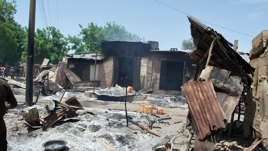 A photo taken on July 4, 2015 shows houses burnt by Boko Haram fighters at Zabarmari, a fishing and farming village near Maiduguri, northeast Nigeria.  Several female suicide bombers in northeast Nigeria blew themselves up amid panicked villagers fleeing a Boko Haram attack, killing scores, the army and witnesses said July 4. The latest carnage in series of attacks that have claimed more than 200 lives in just three days happened on Friday night in Zabarmari village, 10 kilometres (six miles) from the city of Maiduguri, the birthplace of the jihadist group. AFP PHOTO/STRINGER        (Photo credit should read STRINGER/AFP/Getty Images)