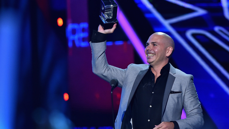 MIAMI, FL - JULY 16:  Pitbull accepts award onstage at Univision's Premios Juventud 2015 at Bank United Center on July 16, 2015 in Miami, Florida.  (Photo by Rodrigo Varela/Getty Images For Univision)