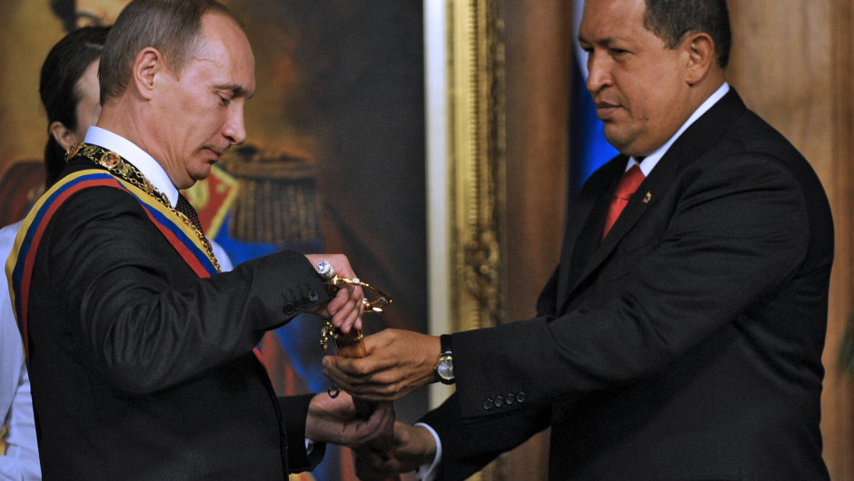 Venezuelan President Hugo Chavez (R) shows a replica of Simon Bolivar's sword to Russian Prime Minister Vladimir Putin, during his visit to Miraflores presidential palace in Caracas on April 2, 2010.  AFP  PHOTO/Juan BARRETO (Photo credit should read JUAN BARRETO/AFP/Getty Images)