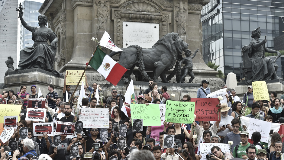 Mexican photojournalists honor their murdered colleague Ruben Espinosa during a demonstration held at the Angel of  Independence square in Mexico City, on August 2, 2015. Espinosa was found shot dead on August 1, 2015, in Mexico City, where he had moved two months ago from Veracruz, after reporting strong threats from the government of the state. Since 2010, 11 journalists have been killed and four others have gone missing in Veracruz. AFP PHOTO/ Yuri CORTEZ        (Photo credit should read YURI CORTEZ/AFP/Getty Images)