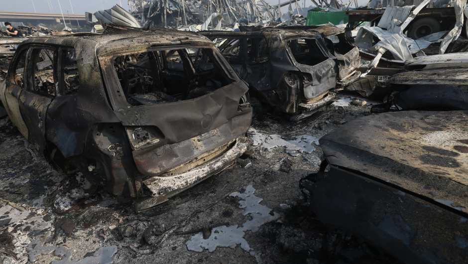 TIANJIN, CHINA - AUGUST 13: (CHINA OUT) Burnt cars are seen in the debris following the explosions of a warehouse in Binhai New Area on August 13, 2015 in Tianjin, China. At least 17 people dead, 32 are in critical condition and at least another 400 injured during the explosions of a warehouse on late Wednesday in Binhai New Area in Tianjin, according to police authority.  (Photo by ChinaFotoPress/ChinaFotoPress via Getty Images)