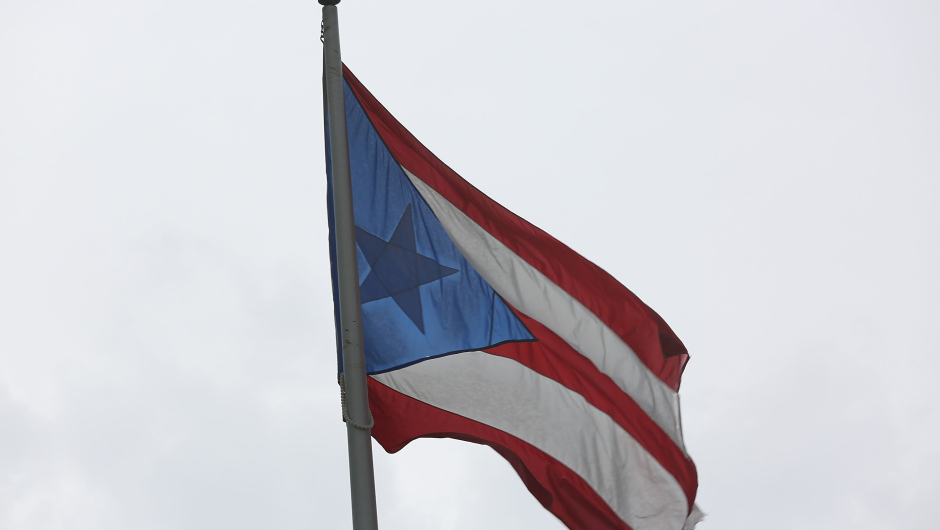 SAN JUAN, PUERTO RICO - JULY 01:  The Puerto Rican flag flies near the Capitol building as the island's residents deal with the government's $72 billion debt on July 1, 2015 in San Juan, Puerto Rico. Governor of Puerto Rico Alejandro García Padilla said in a speech recently that the people of Puerto Rico will have to make sacrifices and share the responsibilities to help pull the island out of debt. (Photo by Joe Raedle/Getty Images)