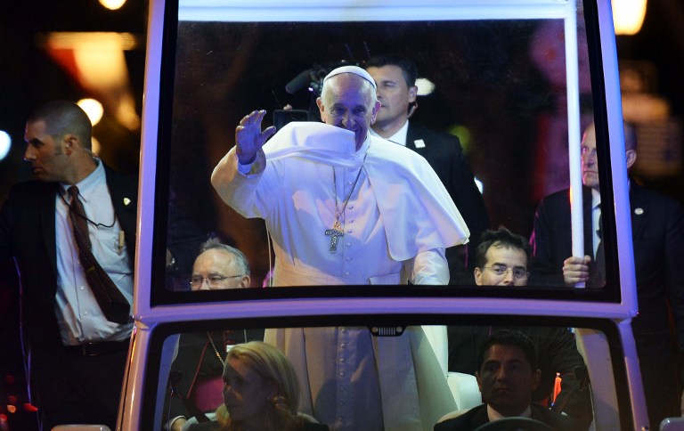 Pope Francis waves at the crowd from the popemobile during a parade in Philadelphia, Pennsylvania, on September 26, 2015. AFP PHOTO/POOL/JEWEL SAMAD